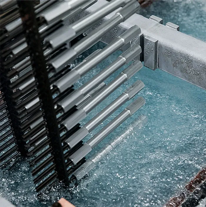 Fully automated anodizing bath with bubbling electrolysis solution treating high volume automotive components.