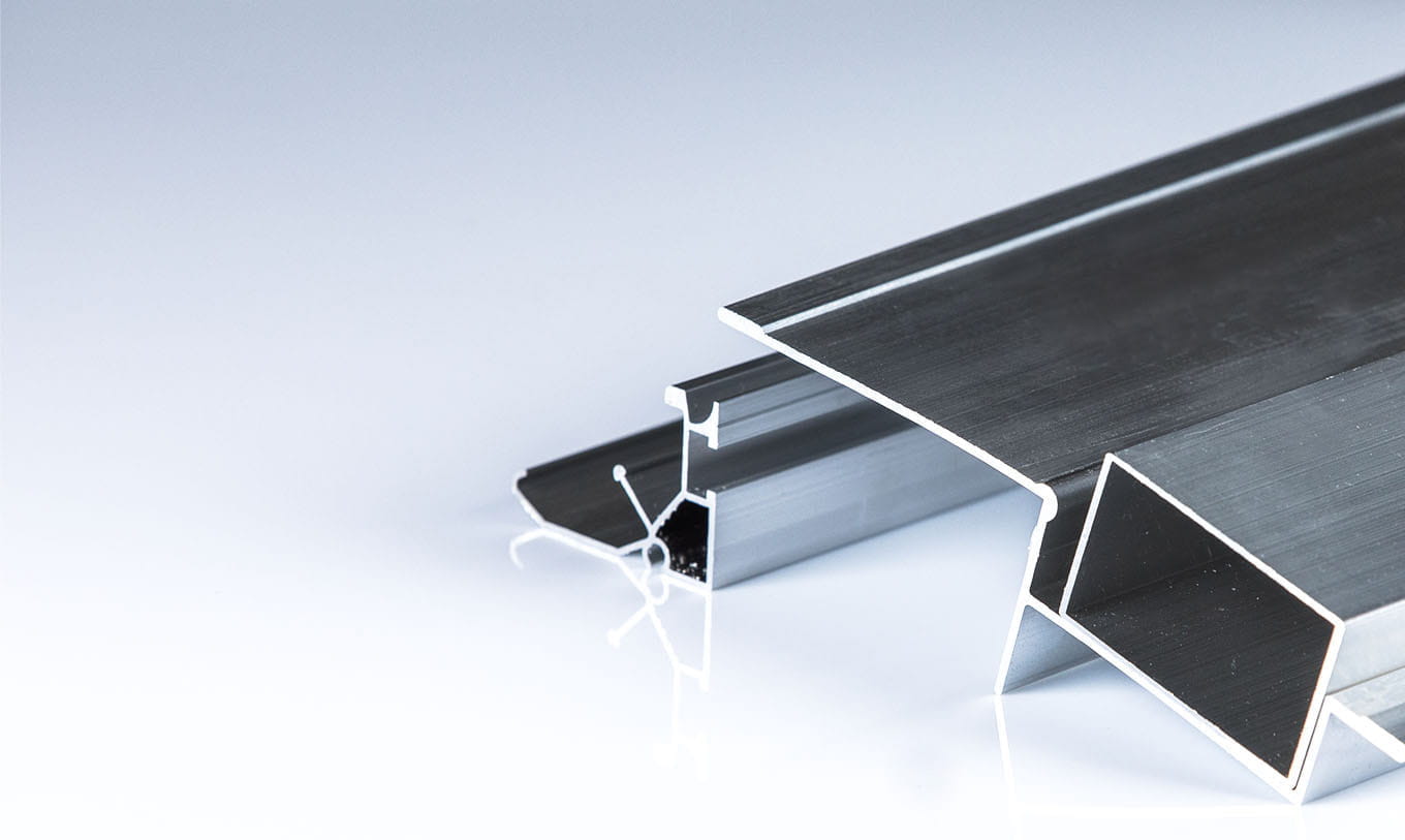 Various precision aluminum extrusion profiles showcasing smooth surface finishes after industrial anodizing treatment at Miyaki.