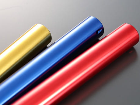 Gold, blue, and red anodized aluminum tubes illustrate the color variations available for specialized surface treatments.