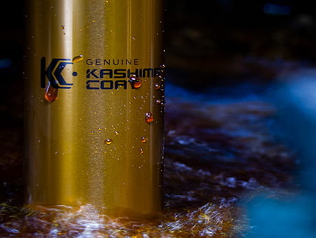 Close-up of a Kashima Coat treated surface with water droplets, highlighting the genuine branding and durable finish.